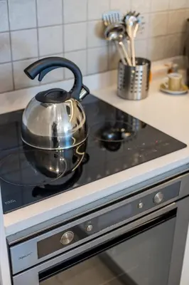 a tea kettle is sitting on top of a stove at Porto Cozy and Design Apartment in Porto Center in Porto