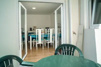 a dining room with a table and chairs in a room at Casa da fonte in Vila Nova de Gaia
