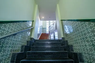 a staircase in a building with black steps and tiles at Large and Charming Apartment Downtown in Porto