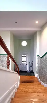 a room with a staircase with a door and a window at Large and Charming Apartment Downtown in Porto