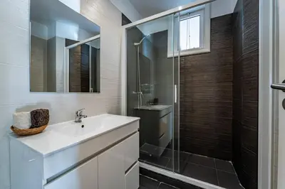 a bathroom with a sink and a shower at Large and Charming Apartment Downtown in Porto