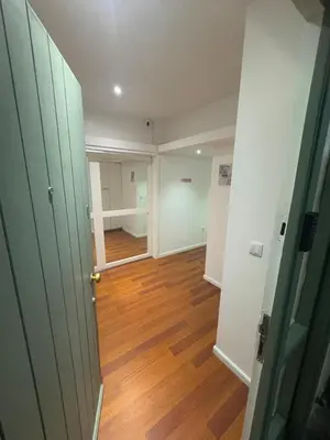 an empty room with a door and a wooden floor at Dormitório Aliados in Porto