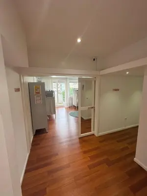 an empty living room with a hard wood floor at Dormitório Aliados in Porto