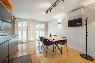 a kitchen and dining room with a table and chairs at 24 Agosto Amazing Triplex by Vacationy in Porto