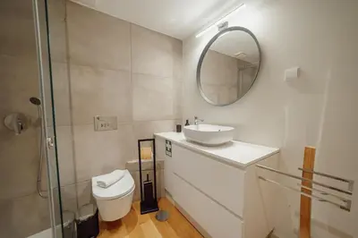 a bathroom with a toilet and a sink and a mirror at 24 Agosto Amazing Triplex by Vacationy in Porto
