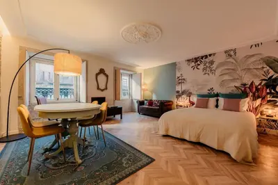 a bedroom with a bed and a table and a desk at 90 Studio in Porto