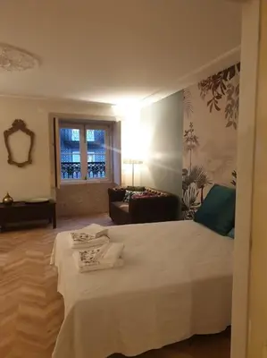 a bedroom with a bed and a living room at 90 Studio in Porto
