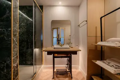 a dressing room with a vanity and a mirror at 90 Studio in Porto