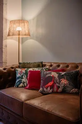 a couch with pillows on it in a living room at 90 Studio in Porto