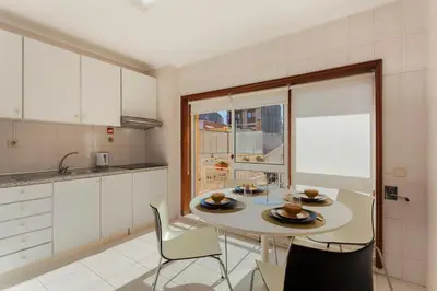 a kitchen with a table and chairs in a kitchen at Guilhermina's Place in Vila Nova de Gaia