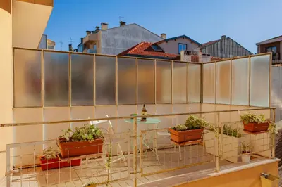 a balcony with potted plants on a building at Guilhermina's Place in Vila Nova de Gaia