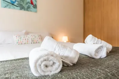 a hotel room with towels on a bed at GuestReady - Even Flow Flat in Porto