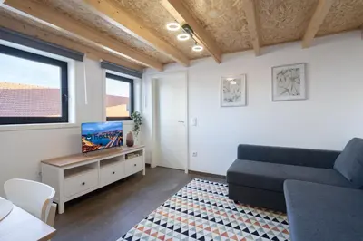 a living room with a couch and a tv at Host Wise - Stylish Duplex House - Terrace & River View in Vila Nova de Gaia