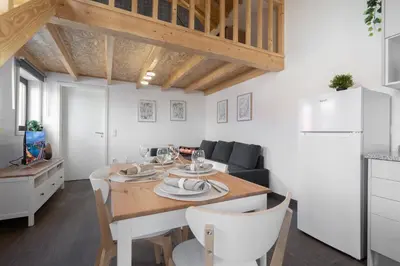 a kitchen and living room with a table and a couch at Host Wise - Stylish Duplex House - Terrace & River View in Vila Nova de Gaia