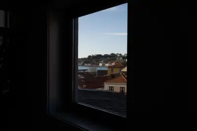 a window with a view of a city at Host Wise - Stylish Duplex House - Terrace & River View in Vila Nova de Gaia