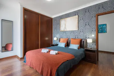 a bedroom with a bed with two towels on it at Host Wise - Spacious Duplex House - Jacuzzi & Terrace in Porto