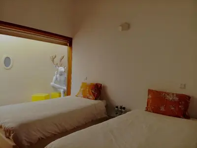 a bedroom with two beds and a deer head on the wall at Groove-Wood Loft in Vila Nova de Gaia