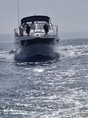 a boat in the water with two people on it at Groove-Wood Loft in Vila Nova de Gaia