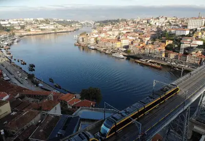 a train on a bridge over a river at Groove-Wood Loft in Vila Nova de Gaia