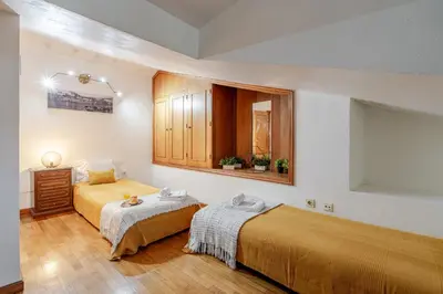 a bedroom with two beds and a mirror at Host Wise - Rustic Bright Flat - City Centre in Porto