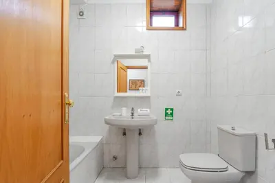 a white bathroom with a toilet and a sink at Host Wise - Rustic Bright Flat - City Centre in Porto