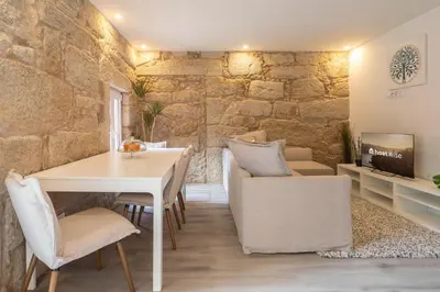 a dining room with a white table and chairs at Host Wise - Modern Comfy Flat in Porto