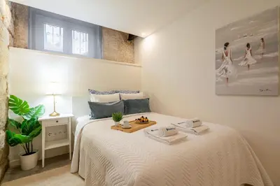 a bedroom with a white bed with a tray on it at Host Wise - Modern Comfy Flat in Porto