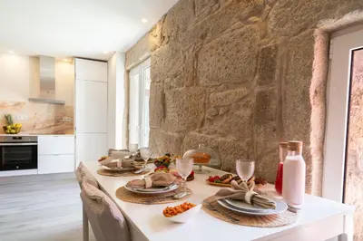 a kitchen with a table with food and wine glasses at Host Wise - Modern Comfy Flat in Porto
