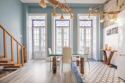 a dining room with a glass table and windows at Host Wise - Deluxe Spacious Flats w Mezzanine in Porto