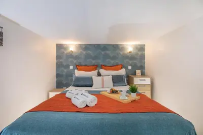 a bedroom with a bed with two towels on it at Host Wise - Deluxe Spacious Flats w Mezzanine in Porto