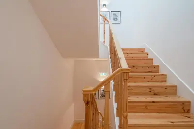 a staircase in a home with wooden steps at Host Wise - Modern Design Duplex w Balcony in Porto