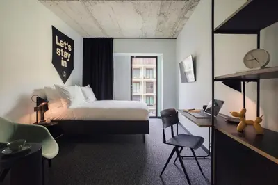 a bedroom with a bed and a sign that says let s stay in at The Social Hub Porto in Porto
