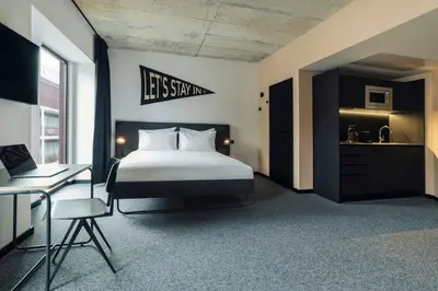 a black tiled bathroom with a sink and a shower at The Social Hub Porto in Porto