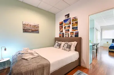 a bedroom with a bed and a desk in a room at Coliseu Oporto Center in Porto