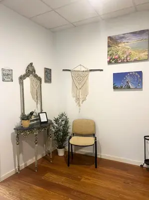 a room with a chair and a mirror and a table at Coliseu Oporto Center in Porto