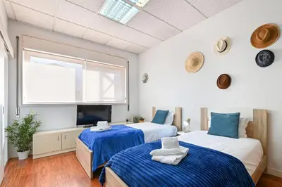 two beds in a room with a window at Coliseu Oporto Center in Porto