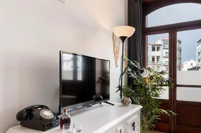 a flat screen tv sitting on top of a table at Poveiros Studio OPorto City Center in Porto