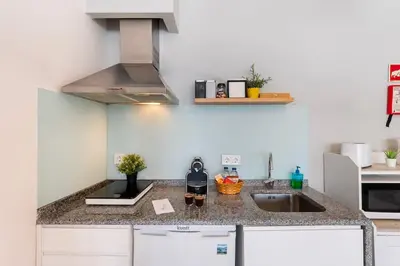 a kitchen with a sink and a stove at Poveiros Studio OPorto City Center in Porto