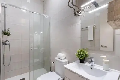 a bathroom with a shower and a toilet and a sink at Poveiros Studio OPorto City Center in Porto