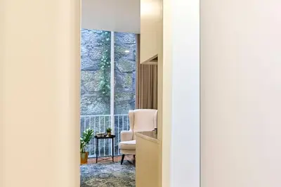a room with a chair and a window at Santa Catarina Oporto City Center in Porto