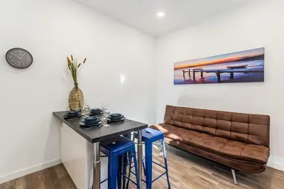a living room with a couch and a table at Bright apartment with garden in Porto