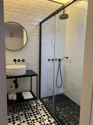 a bathroom with a shower and a sink at Get bindings and books on duplex in Porto