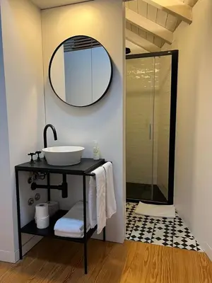 a bathroom with a sink and a mirror at Get bindings and books on duplex in Porto