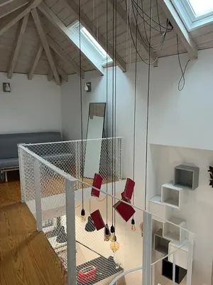 a room with a staircase with shoes hanging from it at Get bindings and books on duplex in Porto