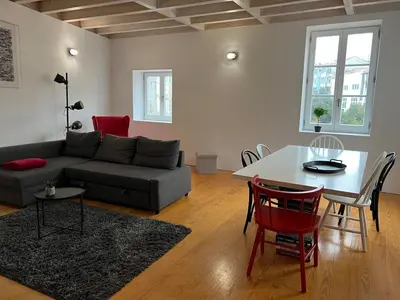 a living room with a couch and a table at Get bindings and books on duplex in Porto