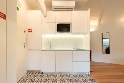 a kitchen with white cabinets and a sink at Host Wise - Large Colourful Flats - Ace Location in Vila Nova de Gaia