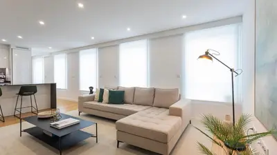a living room with a couch and a table at Morro Premium Apartment w Free Parking in Vila Nova de Gaia