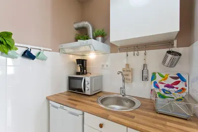 a small kitchen with a sink and a microwave at Host Wise - Sweet Flats - Bolhão City Center in Porto