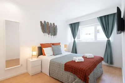 a bedroom with a bed and a window at Host Wise - Sweet Sunny Flat with Balcony in Vila Nova de Gaia