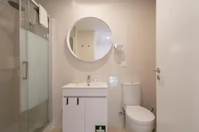 a bathroom with a toilet and a sink and a mirror at Host Wise - Sunny Bright Duplexes & Pool in Vila Nova de Gaia